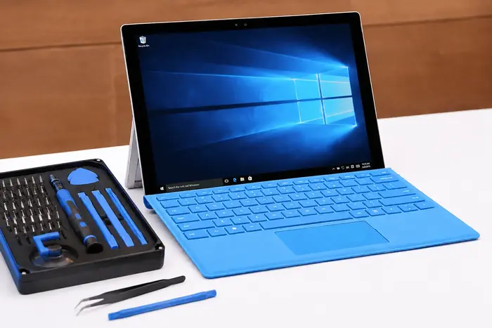 Microsoft Surface Pro with Type Cover beside a precision repair toolkit at My Celcare JLT Dubai